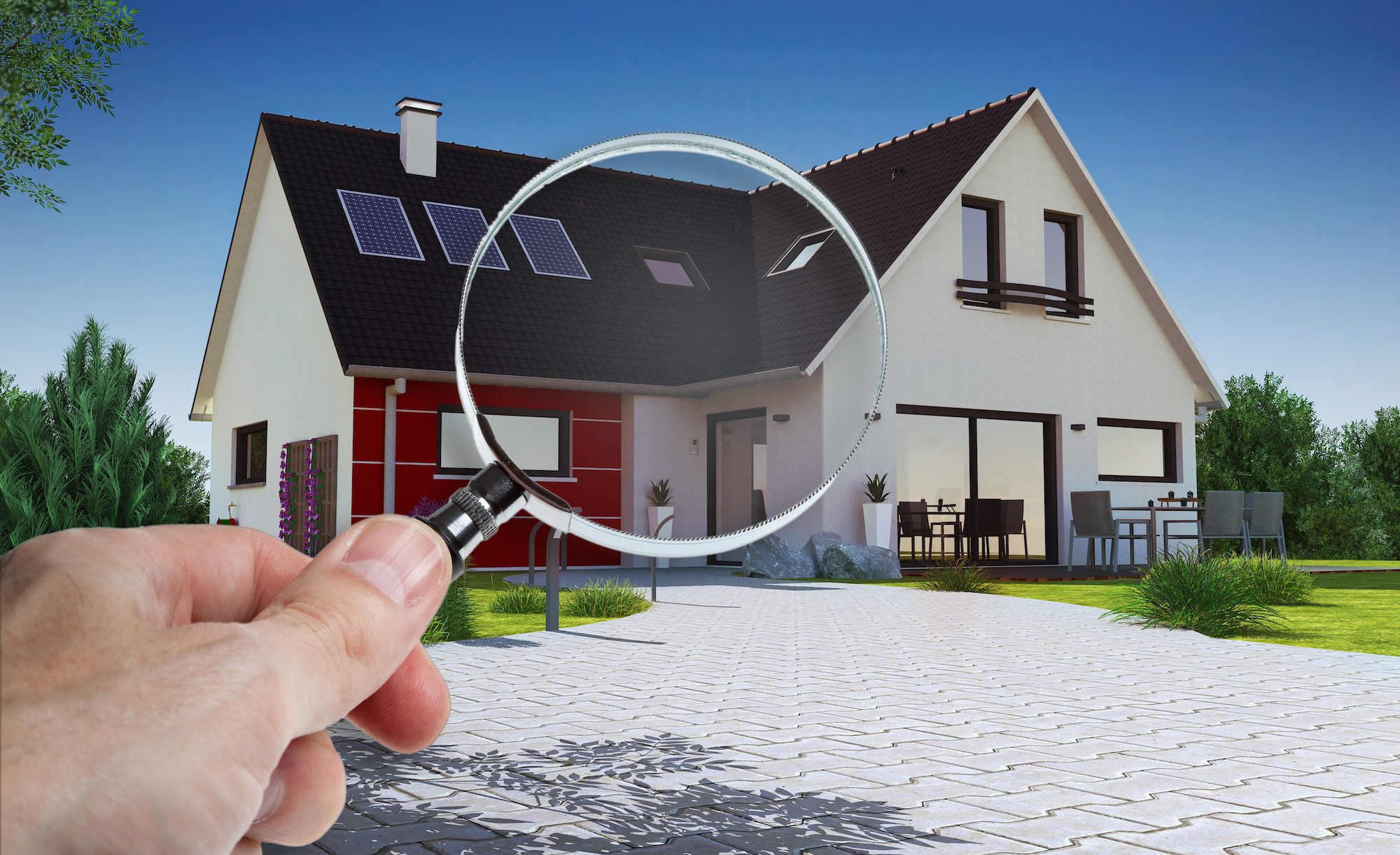 Magnifying glass focused on house roof and windows symbolizing detailed home inspection in Los Angeles