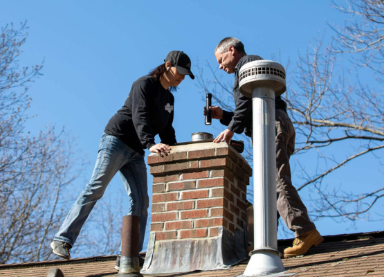 INSPECTION LOS ANGELES performing chimney inspection on residential roof