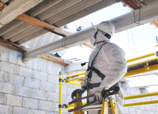 INSPECTION LOS ANGELES inspector in hazmat suit evaluating structural roof framing for safety and hazards